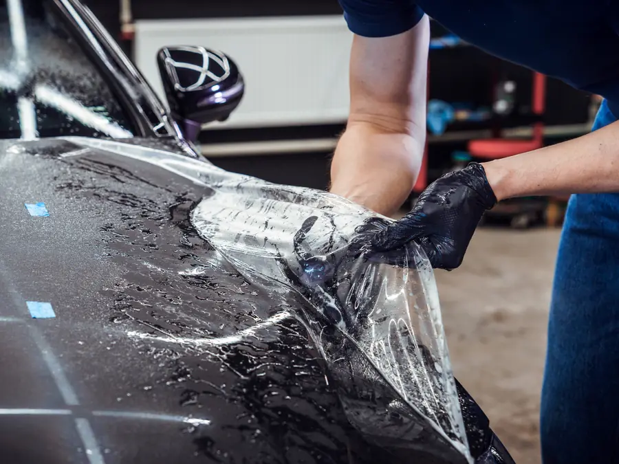 Paint protection film being installed over a vehicle&rsquo;s paint